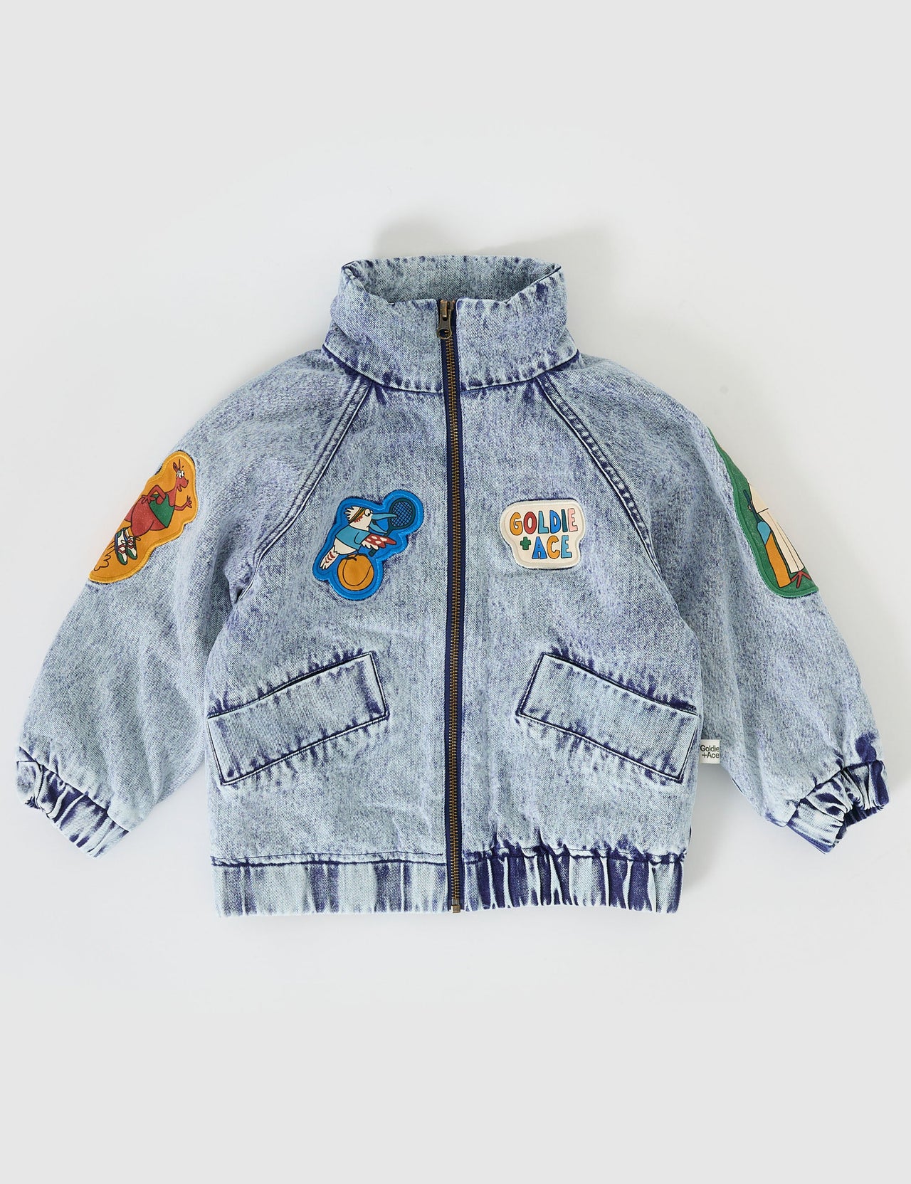 The Goldie + Ace Ari Denim Jacket in Blue Denim pictured on a grey background. The material is denim with poly sherpa lining. It is a jacket made for babies, toddlers and kids.