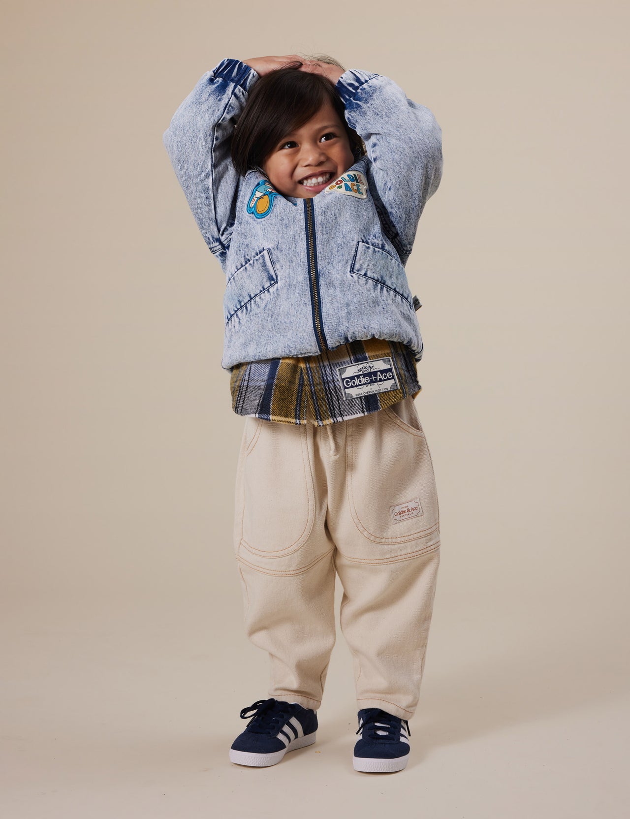 The Goldie + Ace Drew Denim Pocket Pant in Oat pictured on a grey background. The material is cotton denim. It is a bottom made for babies, toddlers and kids.