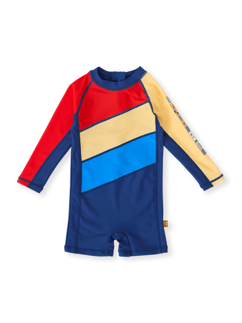 The Goldie + Ace Nautical Flag Short Leg Swimsuit in Blue/Yellow/Red pictured on a transparent background. The material is . It is a swimwear made for babies, toddlers and kids.