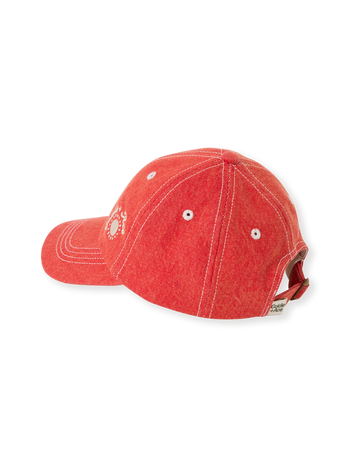 The Goldie + Ace Tate Embroidered Denim Cap in Apple Red pictured on a transparent background. The material is 100% cotton. It is a accessory made for babies, toddlers and kids.