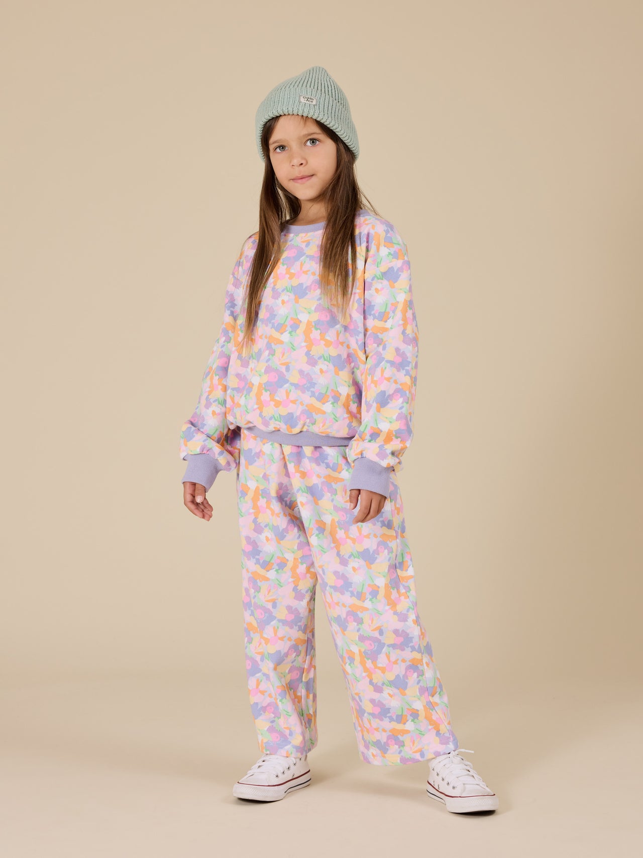 The Goldie + Ace Pastel Bouquet Arlo Wide Leg Pant in Lilac Multi pictured on a transparent background. The material is 100% cotton. It is a bottom made for babies, toddlers and kids.