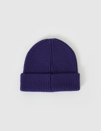 The Goldie + Ace Wool Beanie in Navy pictured on a grey background. The material is 100% merino wool. It is a accessory made for babies, toddlers and kids.